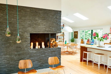 Large mid-century modern open concept light wood floor and beige floor living room photo in Portland with white walls, a standard fireplace, a stone fireplace and no tv
