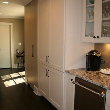 A discreet broom closet is flush with the wall using pivot hinge