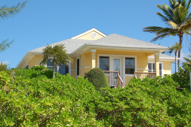 This is an example of a beach style one-storey stucco exterior in DC Metro with a hip roof.