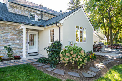 Example of a mid-sized mountain style beige one-story stucco exterior home design in Other with a shingle roof