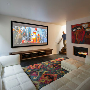 Inspiration for a medium sized modern open plan home cinema in Salt Lake City with white walls, concrete flooring and a projector screen.
