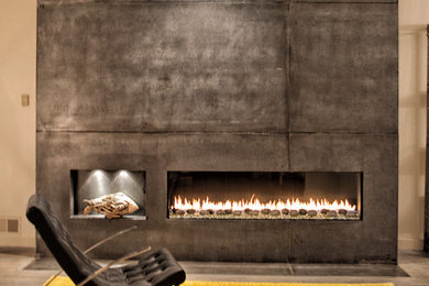 Photo of a large contemporary formal open concept living room in New York with grey walls, concrete floors, a ribbon fireplace, a concrete fireplace surround, no tv and grey floor.