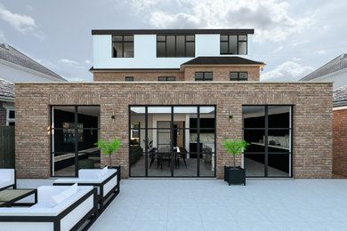 Inspiration for a large and red modern brick and rear house exterior in Oxfordshire with three floors.