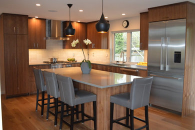 Inspiration for a contemporary light wood floor kitchen remodel in Seattle with an undermount sink, flat-panel cabinets, medium tone wood cabinets, quartz countertops, ceramic backsplash, stainless steel appliances and gray countertops