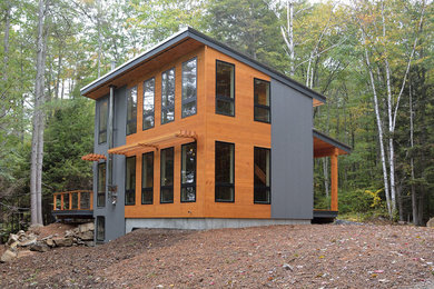 Small trendy two-story exterior home photo in Portland Maine with a shed roof