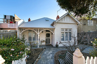 This is an example of a traditional two-storey white exterior in Melbourne with wood siding.