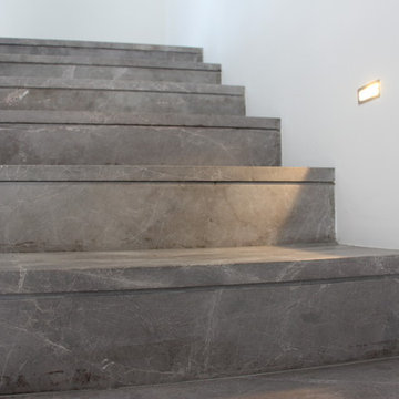 Modern gray marble stairs with crossing glass