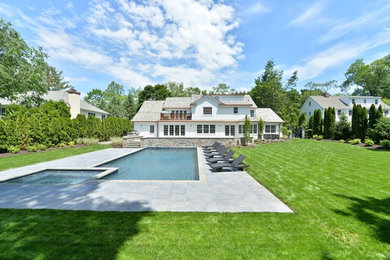 Hot tub - large transitional backyard stone and rectangular lap hot tub idea in New York