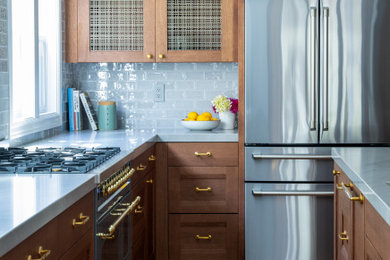 Example of a mid-sized transitional kitchen design in San Francisco with recessed-panel cabinets, dark wood cabinets and an island