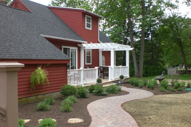 Inspiration for a mid-sized timeless backyard patio remodel in Orange County with decking and a pergola