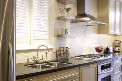 Eat-in kitchen - small transitional galley medium tone wood floor eat-in kitchen idea in Toronto with an undermount sink, raised-panel cabinets, beige cabinets, granite countertops, beige backsplash, porcelain backsplash, stainless steel appliances and no island
