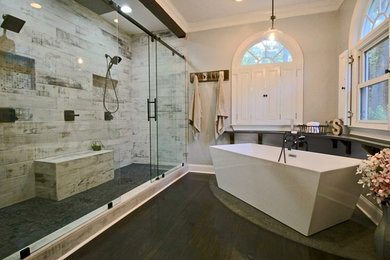 Large transitional master bathroom in Raleigh with a freestanding tub, a double shower, black and white tile, porcelain tile, grey walls, ceramic floors, black floor and a sliding shower screen.