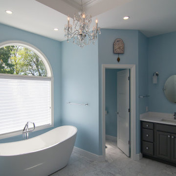 Traditional master bath utilizing frosted and clear glass to allow for needed pr