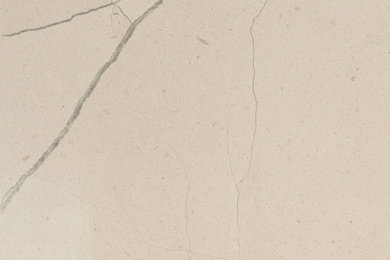 Honed Atlantic White limestone, warm cream surface with fine hairline veins