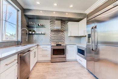 Mid-sized minimalist u-shaped beige floor eat-in kitchen photo in Phoenix with gray backsplash, metal backsplash, stainless steel appliances and no island