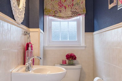 Inspiration for a small transitional beige tile and porcelain tile porcelain tile and beige floor powder room remodel in New York with a one-piece toilet, blue walls and a pedestal sink