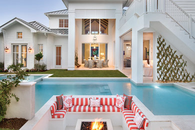 Design ideas for an expansive beach style backyard patio in Miami with a fire feature.