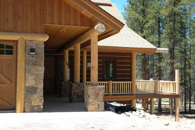 Large rustic brown two-story wood exterior home idea in Denver