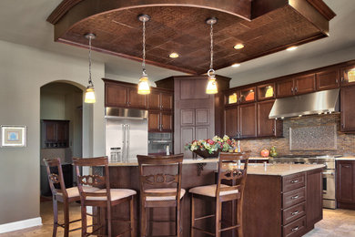 Example of a huge classic u-shaped porcelain tile eat-in kitchen design in Omaha with a double-bowl sink, beaded inset cabinets, dark wood cabinets, granite countertops, beige backsplash, stone tile backsplash, stainless steel appliances and an island