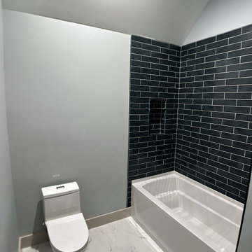 Elegant Guest Bath: Soft Terracotta Walls, Marble Vanity, and Modern Black Fixtu