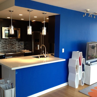 Inspiration for a small contemporary open plan home cinema in New York with blue walls, bamboo flooring and a wall mounted tv.