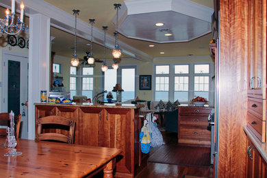 Eat-in kitchen - large traditional medium tone wood floor eat-in kitchen idea in New York with an undermount sink, flat-panel cabinets, medium tone wood cabinets, granite countertops, stainless steel appliances and an island