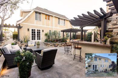 Mid-sized elegant backyard concrete patio photo in Los Angeles with a pergola