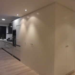 Large contemporary kitchen pantry remodeling - Inspiration for a large contemporary l-shaped light wood floor kitchen pantry remodel in Barcelona with flat-panel cabinets, white cabinets and no island