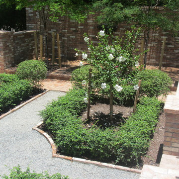 Courtyard garden brick walls and flowering hibiscus