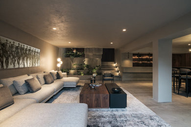 Ejemplo de salón para visitas tipo loft y gris y negro actual de tamaño medio con paredes grises, suelo de cemento y suelo gris