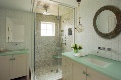 Inspiration for a beach style bathroom in Providence with an undermount sink, shaker cabinets, white cabinets, a corner shower, beige tile, white walls and green benchtops.