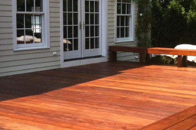 This is an example of a mid-sized backyard deck in New York with no cover.