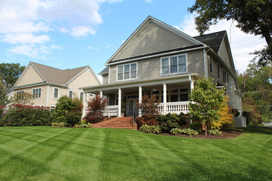 Large transitional beige two-story wood exterior home photo in DC Metro with a hip roof
