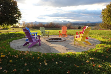Photo of a mid-sized traditional partial sun backyard brick formal garden in Burlington with a fire pit for fall.