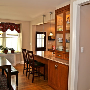 Warm Wood Kitchen Remodel | Angled Granite Island & Integrated Display Cabinets