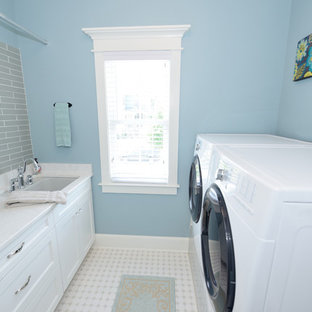 Photo of a small traditional galley separated utility room in Raleigh with white cabinets, blue walls, a side by side washer and dryer, a submerged sink, shaker cabinets, soapstone worktops, ceramic flooring and white floors.