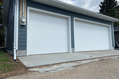 Example of a large detached three-car garage design in Edmonton