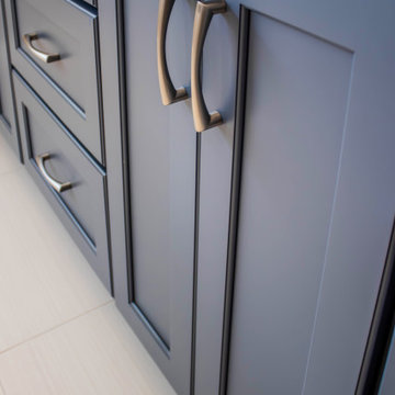 Primary Bathroom with Blue-Gray Vanity and Deep Blue Tiled Feature Wall