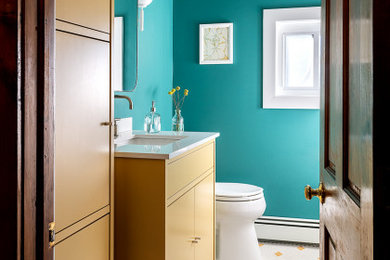 Inspiration for a mid-sized modern master mosaic tile floor, multicolored floor and single-sink bathroom remodel in Philadelphia with flat-panel cabinets, yellow cabinets, a two-piece toilet, green walls, an undermount sink, quartz countertops, white countertops and a freestanding vanity