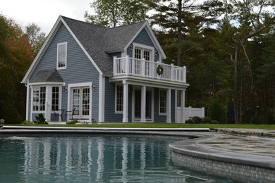 Large mountain style backyard stone and custom-shaped pool photo in Boston