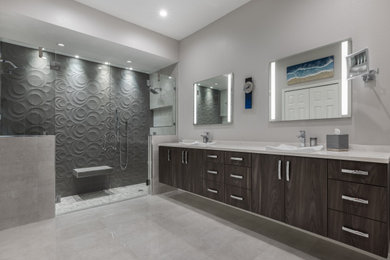 Inspiration for a mid-sized contemporary master gray tile and ceramic tile double-sink bathroom remodel in Tampa with brown cabinets, a one-piece toilet, gray walls, a drop-in sink, granite countertops, a hinged shower door, white countertops and a floating vanity