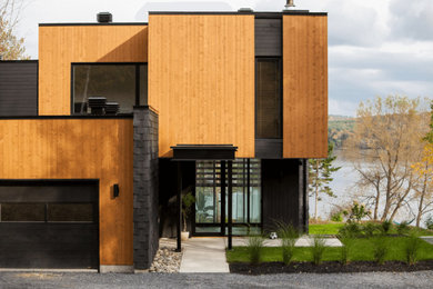 Minimalist multicolored two-story wood exterior home photo in Montreal