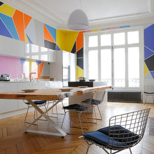 Стильный дизайн: гостиная-столовая среднего размера в современном стиле с разноцветными стенами и паркетным полом среднего тона - последний тренд