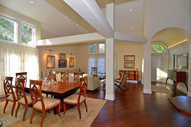 Great room - large traditional medium tone wood floor great room idea in Philadelphia with yellow walls and no fireplace