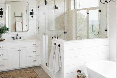 Large transitional master gray tile gray floor, single-sink and shiplap wall bathroom photo in Austin with recessed-panel cabinets, white cabinets, white walls, a hinged shower door, white countertops and a built-in vanity
