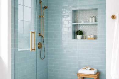 Beach style blue tile mosaic tile floor and white floor alcove shower photo in Atlanta with white walls, a hinged shower door and a niche