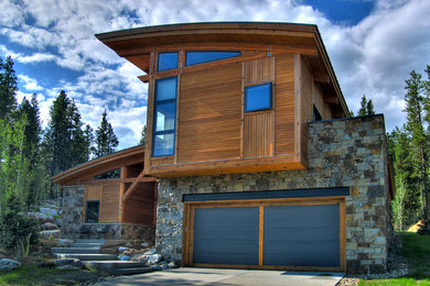 Example of a trendy stone exterior home design in Denver