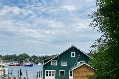 Beach style green wood and shingle gable roof photo in Detroit with a shingle roof and a black roof