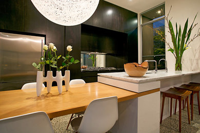 Contemporary single-wall eat-in kitchen in Adelaide with an undermount sink, dark wood cabinets, marble benchtops, stainless steel appliances, concrete floors and with island.