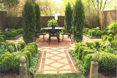 Photo of a large traditional backyard brick formal garden in New York.